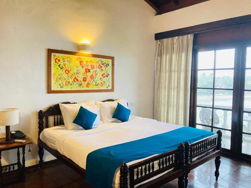Deluxe Double Room at Closenberg Hotel with sea view and colonial bedframe