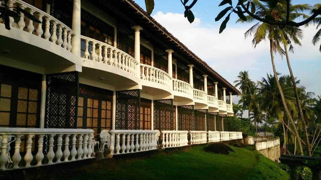 Colonial heritage architecture at Closenberg Hotel framed by palms