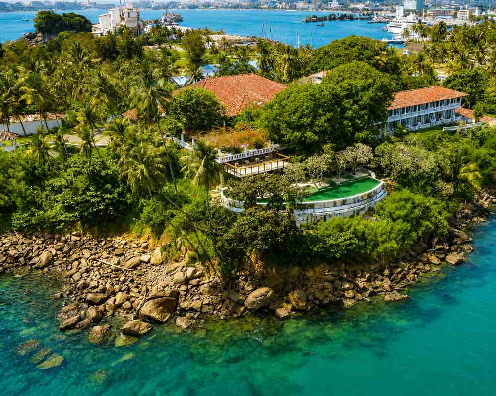 Aerial view of Closenberg Hotel's headland above the reef, with Galle harbour beyond
